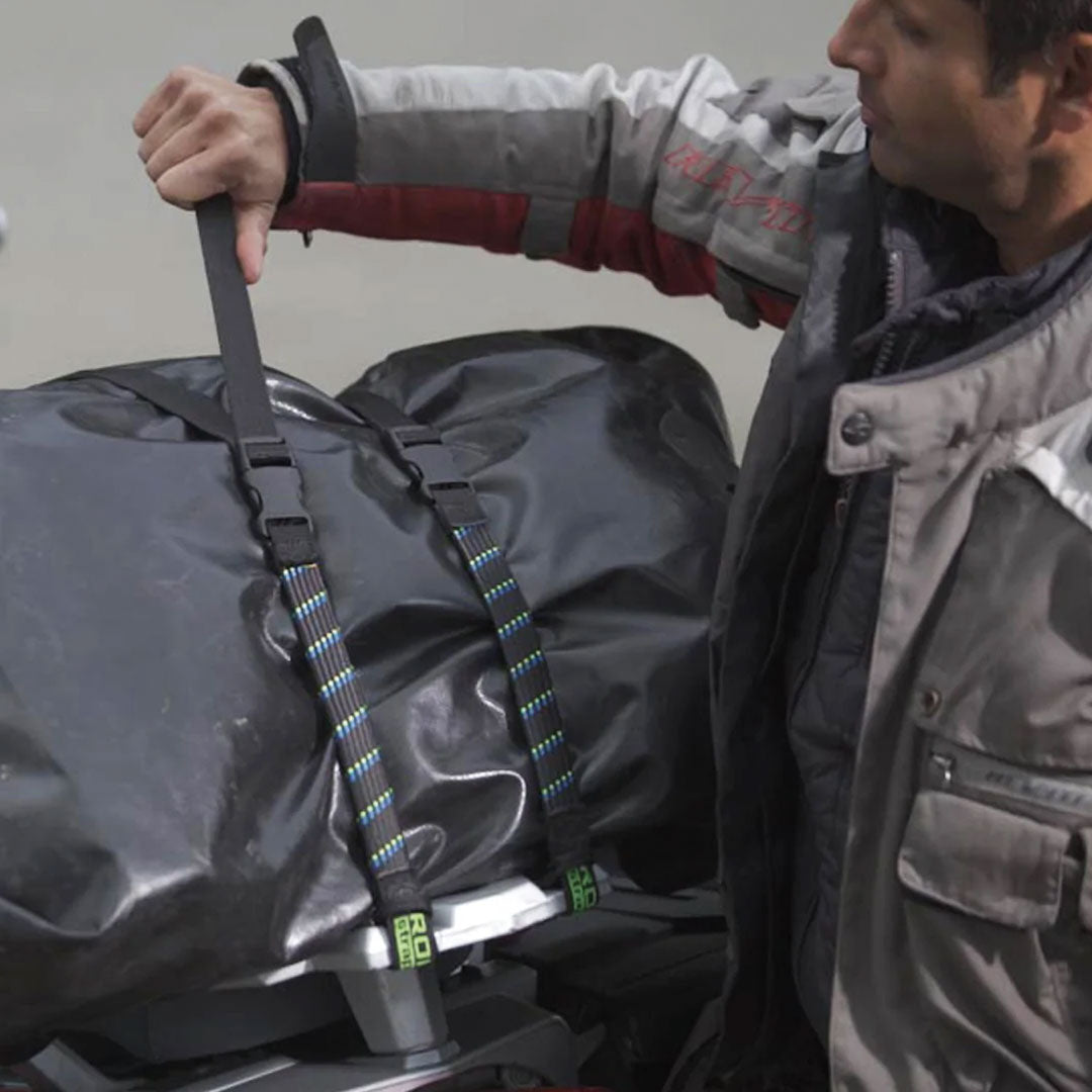 ROKStraps Motorcycle / ATV Stretch Straps being fastened onto the back of a bike using quick-release buckles, securing luggage safely